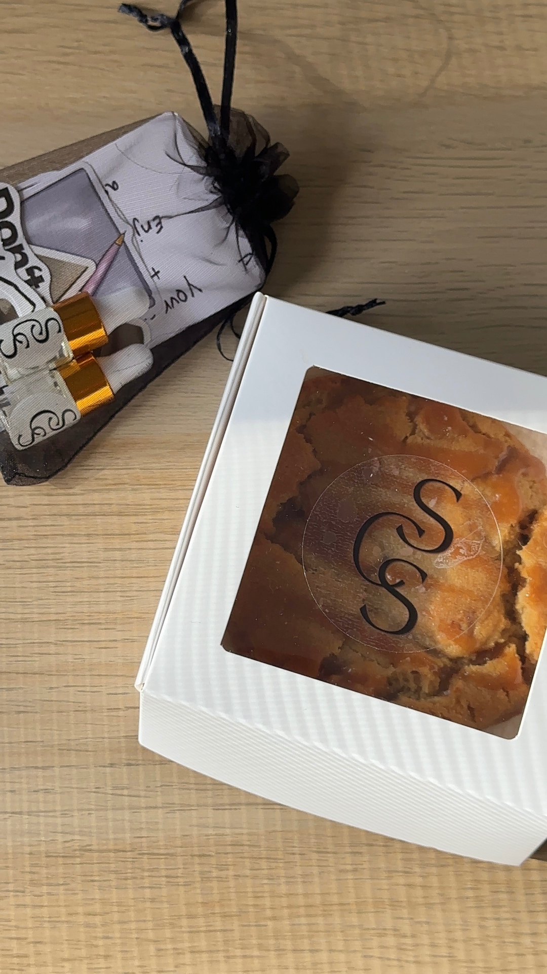 SCS cookie box beside a branded organza gift pouch