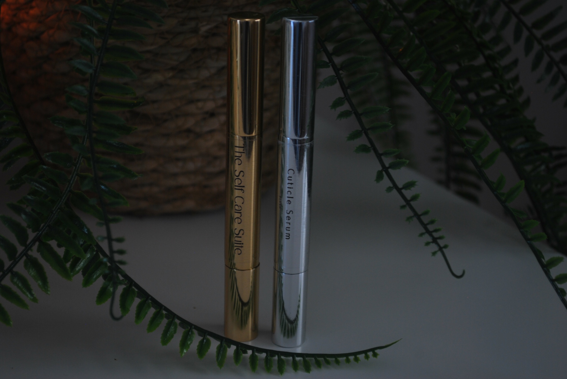 Gold and silver cuticle serum pens with caramel cubes and vanilla orchid