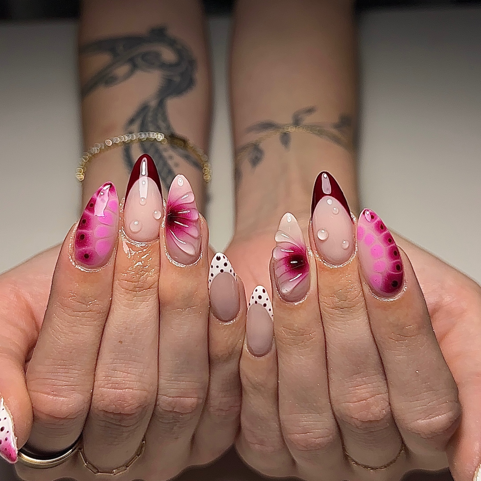 Pink butterfly nail art with dew drops