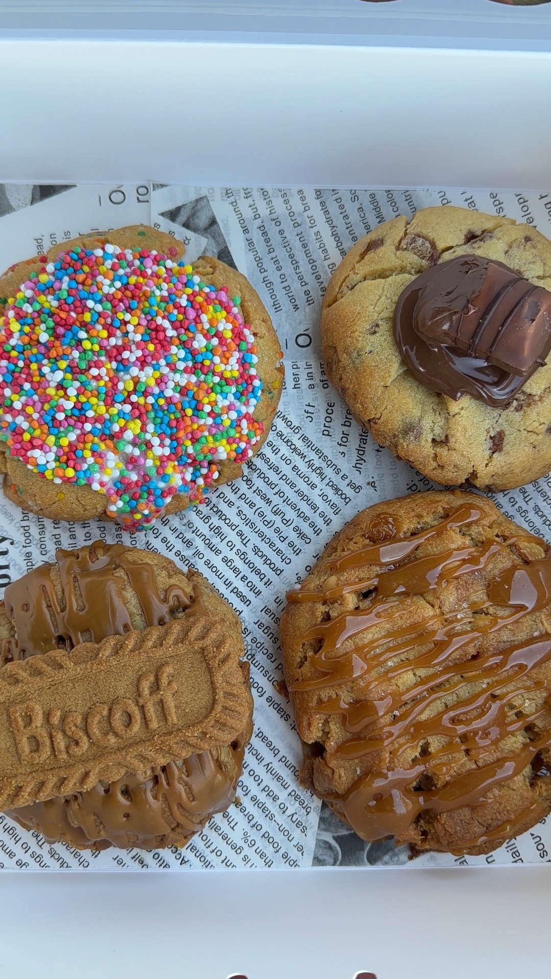 A box of four Self Care Sweets: dot cake, Nutella Bueno, Biscoff and salted caramel