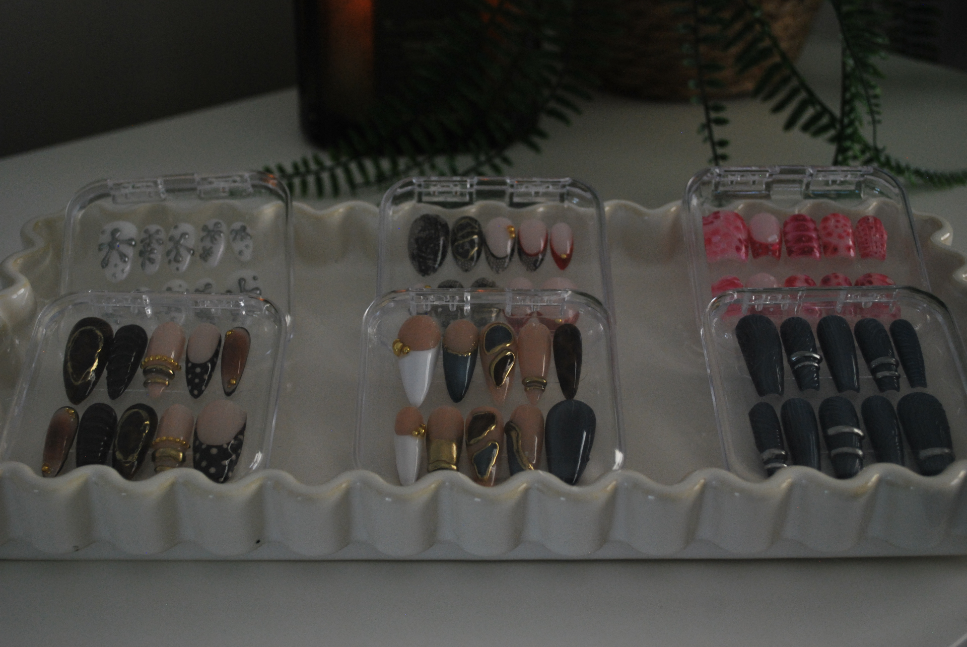 Luxury custom press-on nails arranged on cream marble